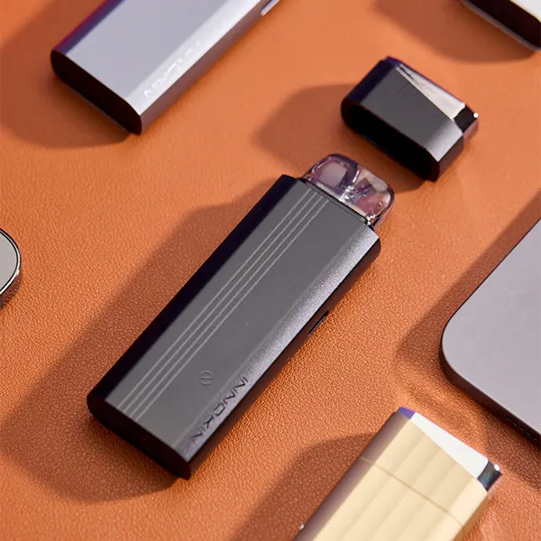 Innokin Klypse Plus Pod Kit in Dunkelgrau auf braunem Leder, Seitenansicht mit Pod